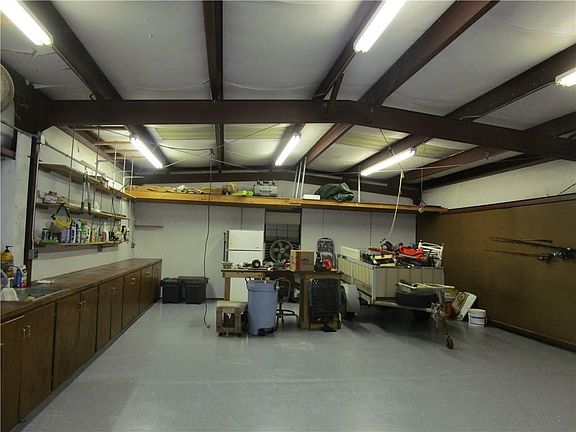 Inside view of metal workshop with freshly painted cement floor.
