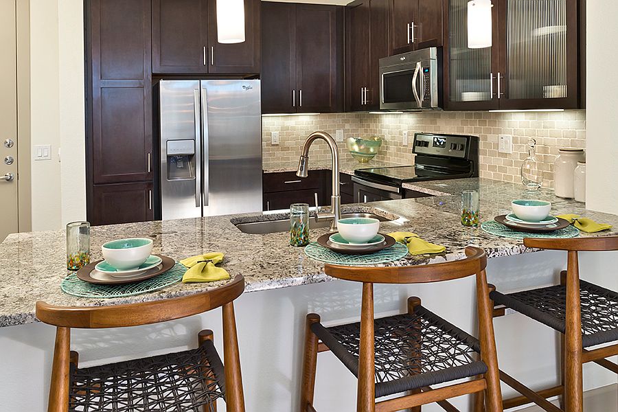 Granite or quartz countertops with designer backsplash