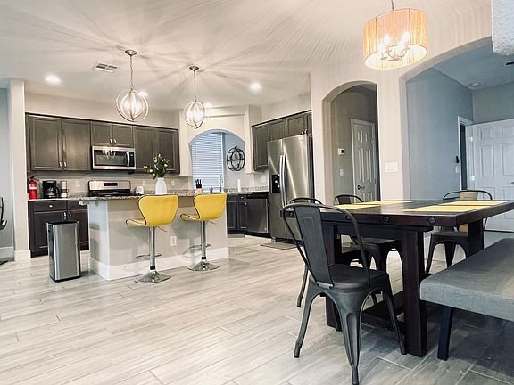 The bar overlooks the kitchen with all modern appliances