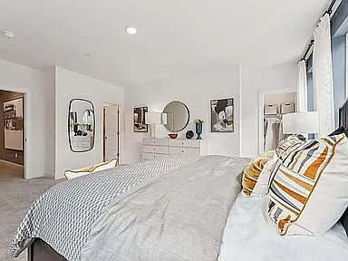 The spacious primary suite offers a private retreat with access to two walk-in closets and a beautifully appointed en-suite bathroom.