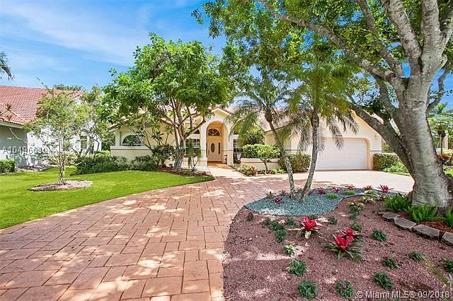 Beautiful and mature landscaping presents this wonderful family home- circular stamped concrete driveway with 2 car garage