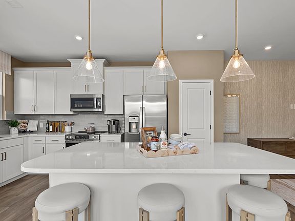 The Rochester Plan by DRB homes kitchen with island in Charlotte, NC.