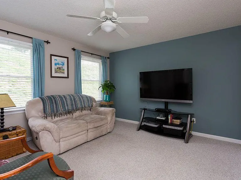 downstairs main bedroom with shared en suite bathroom used as a master or a den.