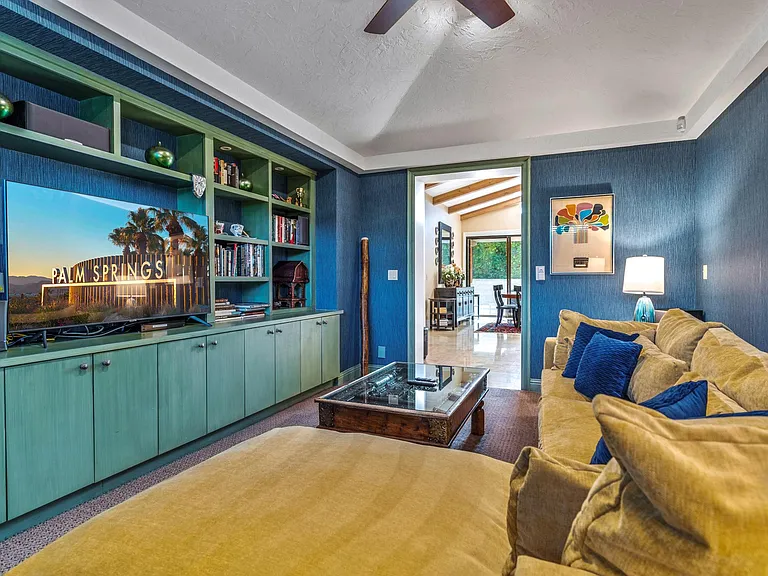 The t.v. den with shelves full of books and Smart t.v.