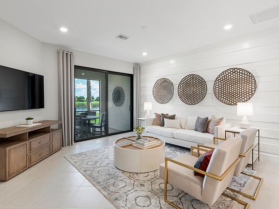 Model Representation Gathering room with sliding glass doors leading to an extended patio with natu