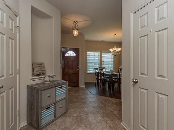 View from hallway off of living area, with powder room and HUGE storage/coat closet.