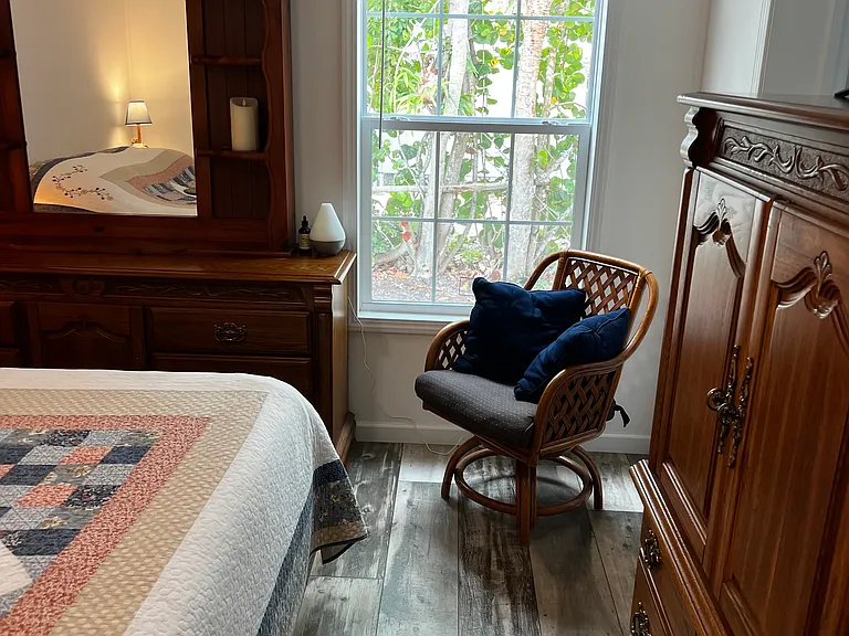 Master Bedroom. Showing comfy chair in the corner and two dressers.