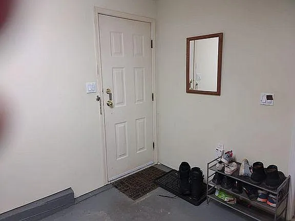 Inside the entry door, in the garage.