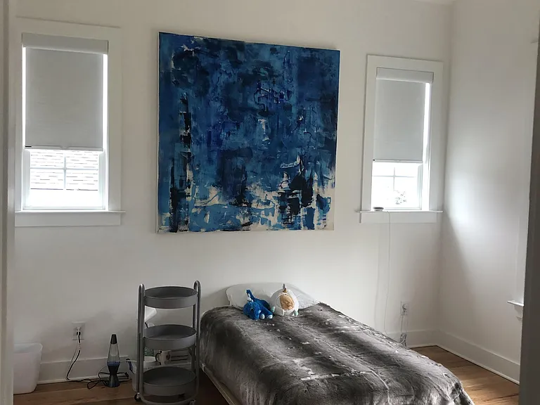 Bedroom 3 with vaulted ceiling and fan.
