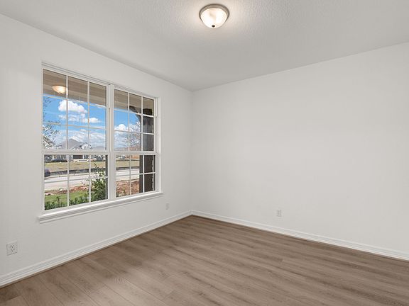 Bright and spacious open room, perfect for a home office, formal living room, or versatile space to