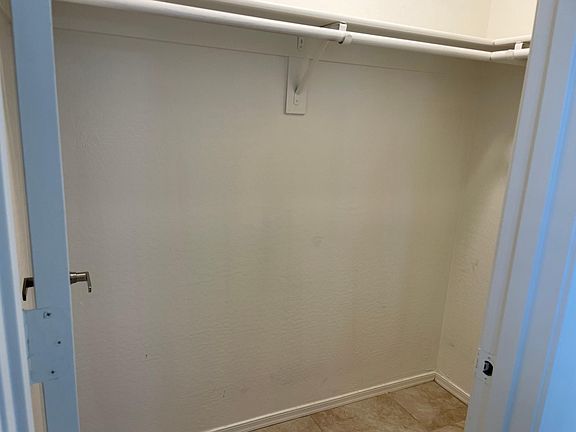 Walk in closet of the downstairs bedroom.