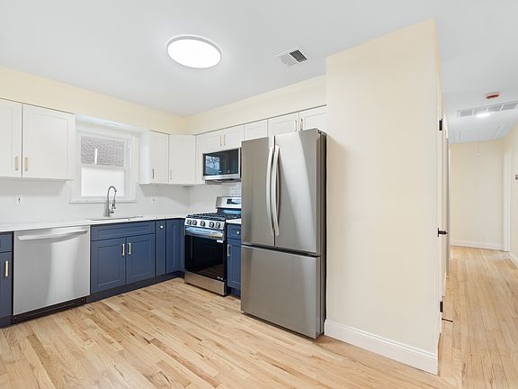 Renovated kitchen with view of hallway