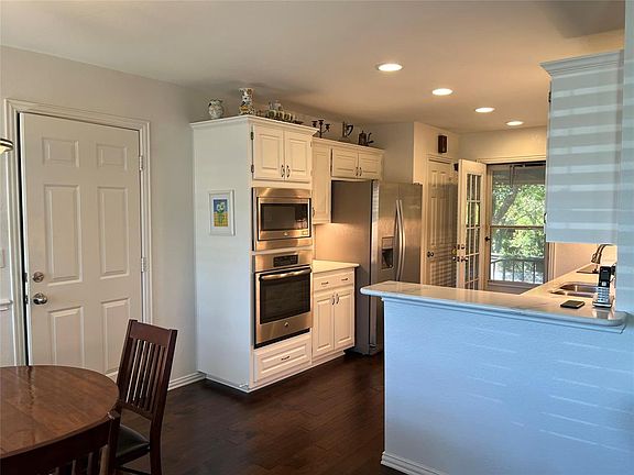 Dining room opens to the kit with updated SS appliance, natural stone counter tops and access to the backyard.