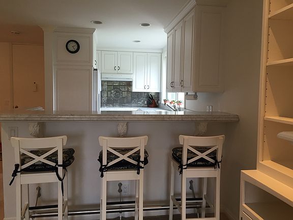 Kitchen with beautiful marble counters and bar