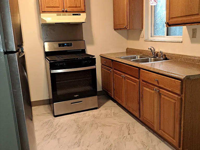 Kitchen with stainless gas range, stainless large refrigerator, garbage disposal, lots of storage