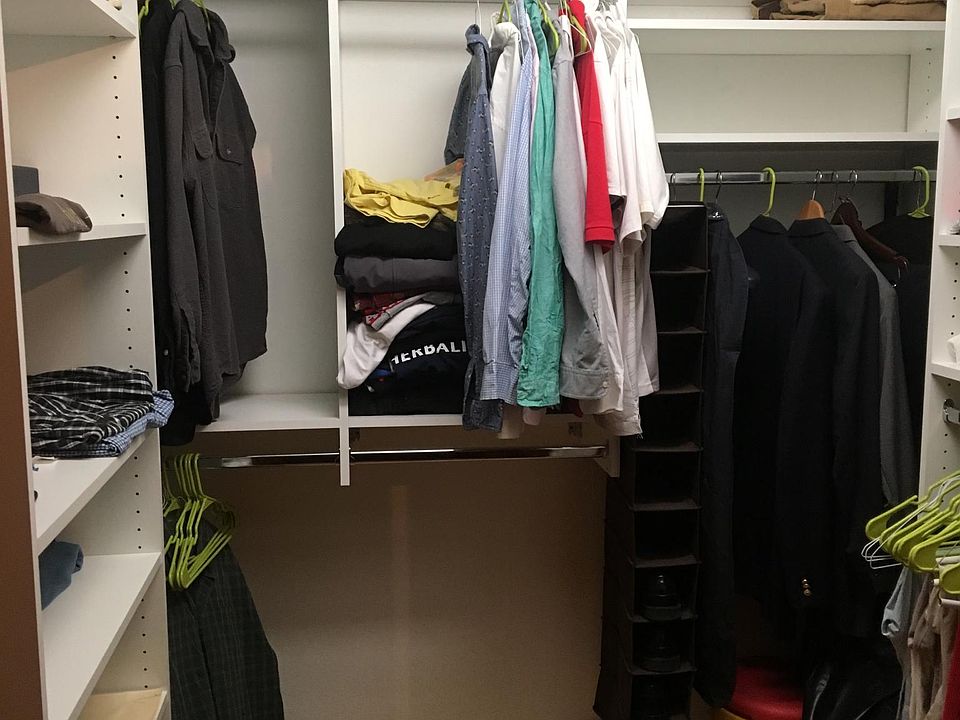 Large walk-in closet with custom closet system.