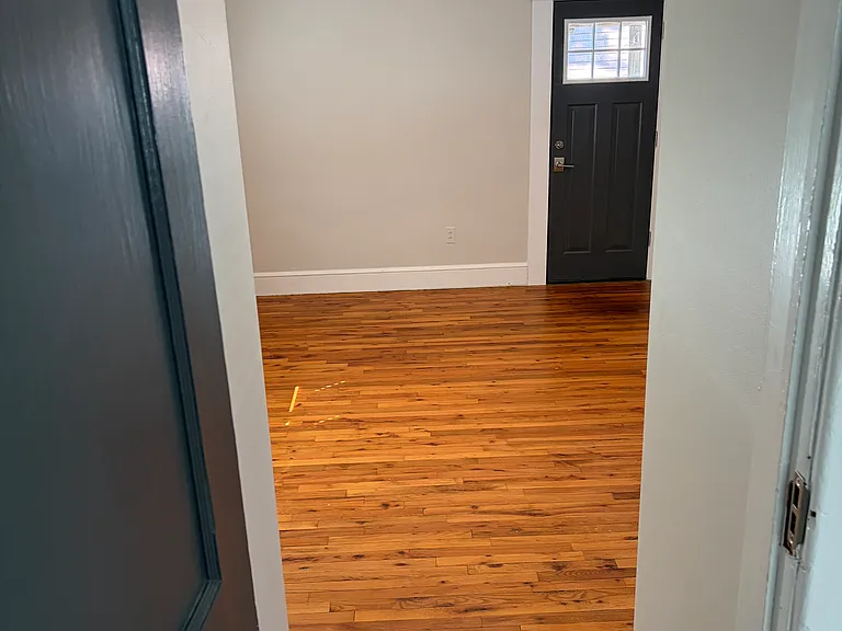 Primary bedroom with vaulted ceiling. rear door leads to private patio area.