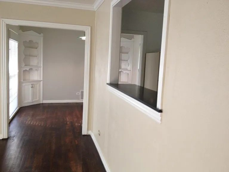 Looking into dining room with original corner cabinets.