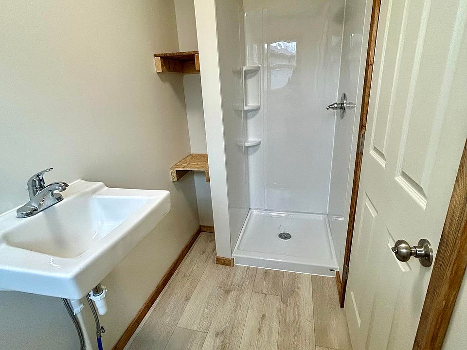 Bathroom; shower side, with storage shelving.