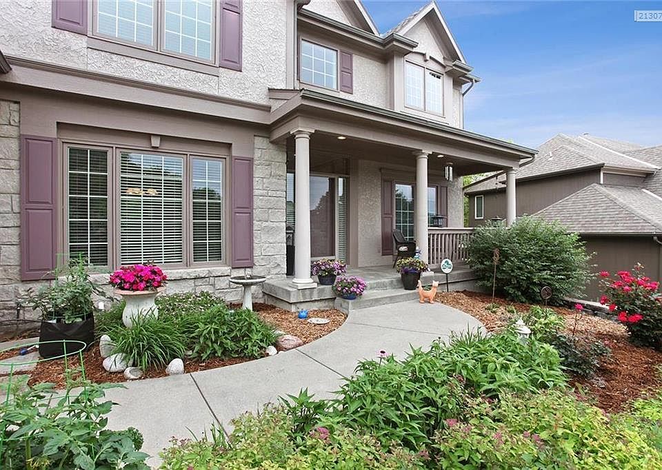 Come & sit & visit on this gorgeous front porch that says Welcome Home!