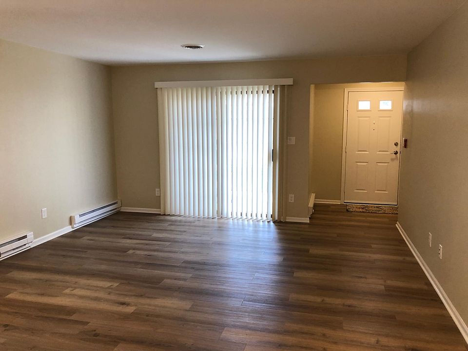 Living Room with new vertical blinds leading out to patio area.