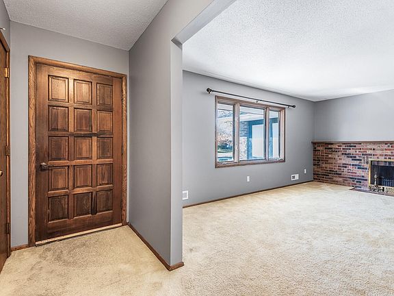 Front entry and Living Room w/ wood burning Fireplace