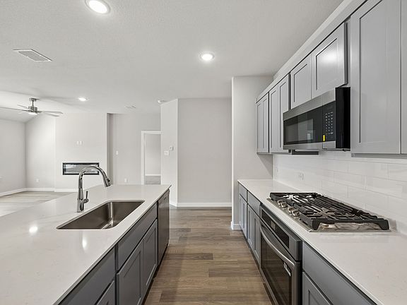 Kitchen in the Emmy II home plan by Trophy Signature Homes - REPRESENTATIVE PHOTO