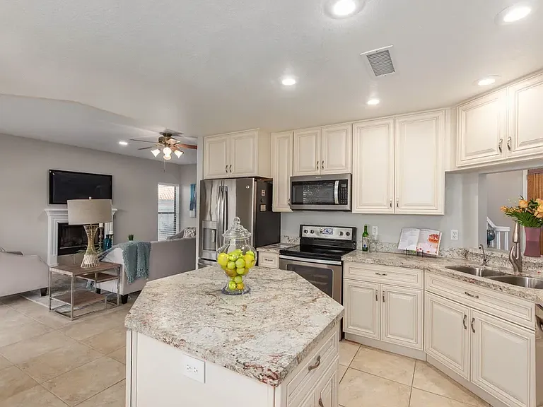Eat in kitchen overlooking the family room with wood fireplace