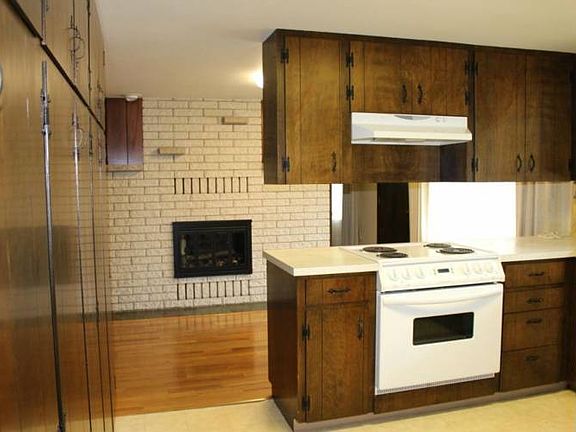 From the kitchen you can see the wood-burning fireplace in the Dining Rm. There is a full wall of pantry space on the left!