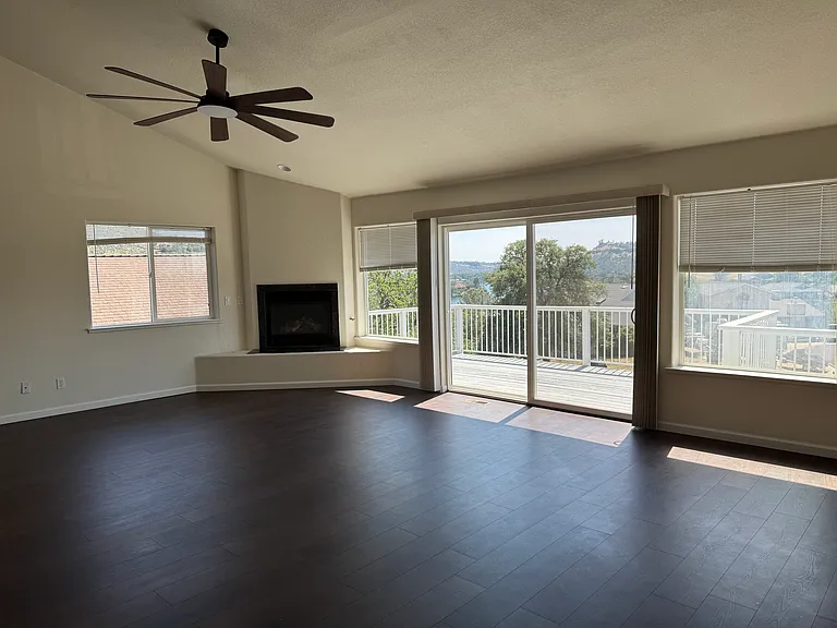 Living room with fireplace and vaulted ceiling