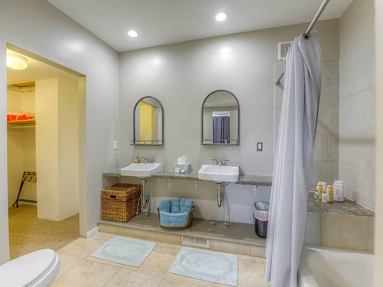 Primary bedroom ensuite bathroom with tub/shower combo and large walk in closet