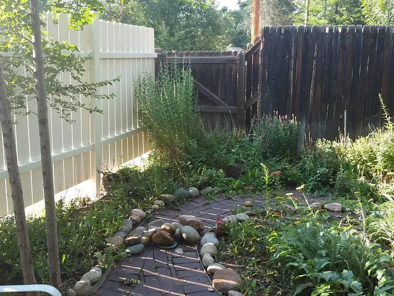 Fenced private yard with pond. Landscaping maintained by property managers.