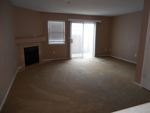 Living Room with Fireplace and Private Fenced Patio