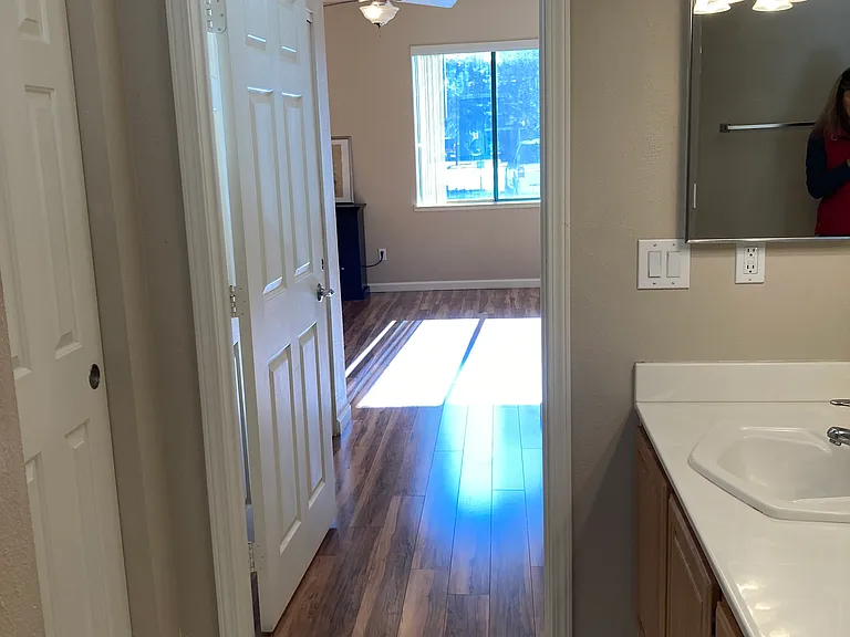 Primary Bathroom looking out past double closets to Primary Bedroom.