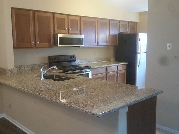 Kitchen with newer (2020) granite countertop, sink, faucet, and SS appliances.
