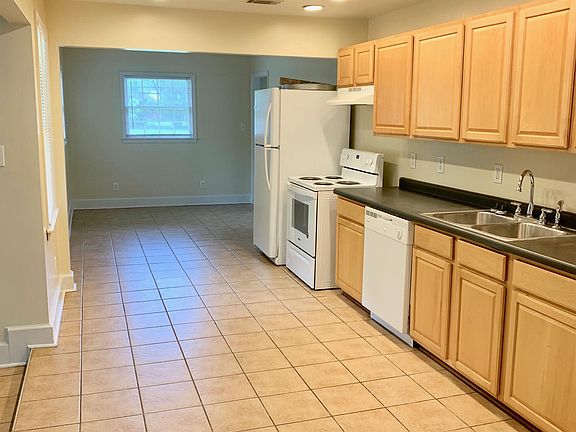 Step down sunroom to left. Rear entrance, laundry and 3rd BR off hallway (not shown) past Fridge