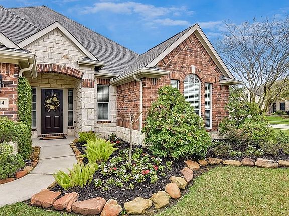 Fabulous front view of the mixed brick and stone accents that invites you to your new comfort zone. Lovely landscaping that is easy to maintain as well.