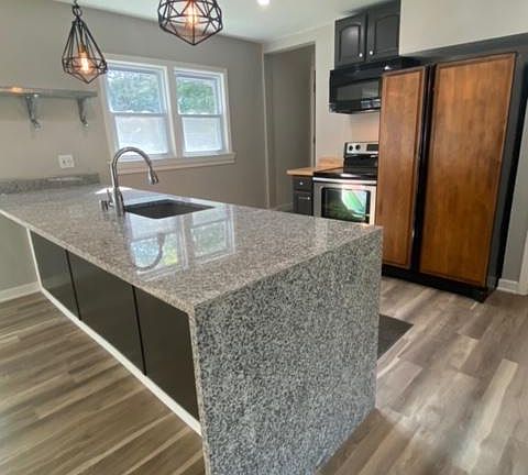 View of kitchen island with waterfall edges.