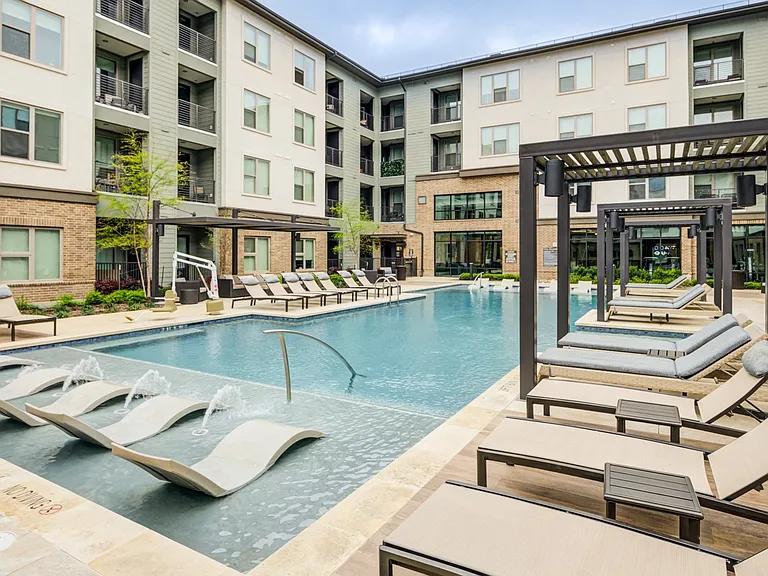 Resort-Style Pool With In-Water Loungers and Private Cabanas