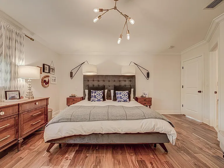 Extra large wall scones with light switches over nightstands.