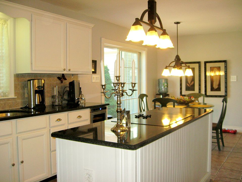 Granite center island, cook top stove, wine cooler 