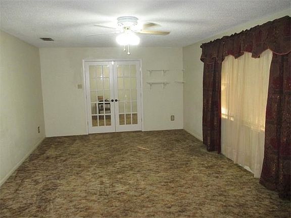 Front Living room. Window faces the front yard. French doors to the formal dining area.