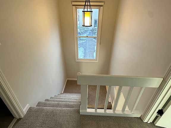 Stairway between main living area and upstairs bedrooms/bathroom.