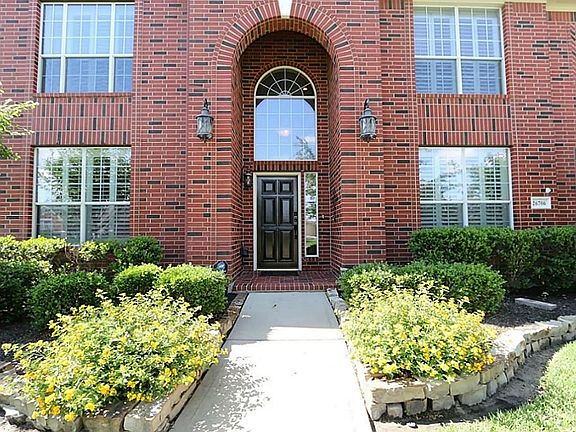 This stunning brick home has great curb appeal! The two story arched patio with stone border flower 