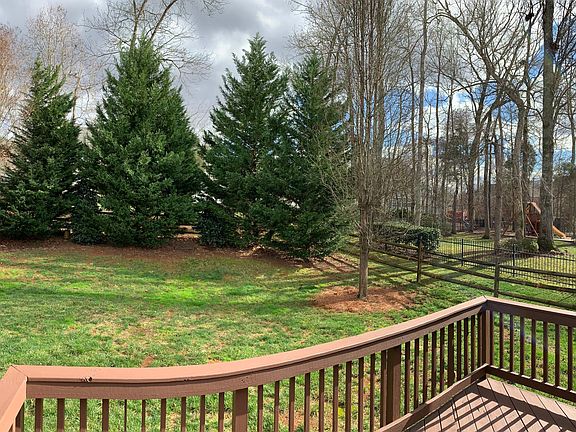 Large, private backyard with deck and fence. Fence is split rail, with wire between the rails to keep your pet enclosed.