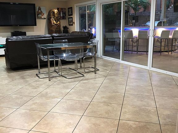 Huge lounge room flows into outdoor entertainment area thru 10 foot slider opening and is separate from living room with fireplace