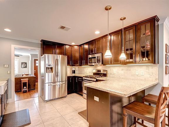 Another view of the kitchen and breakfast bar.