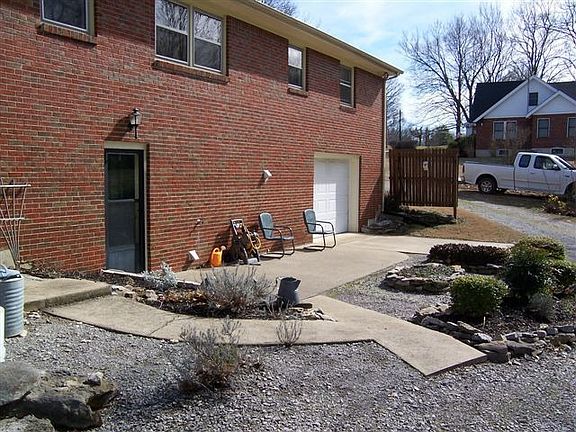 Back patio, sidewalks and nicely landscaped.