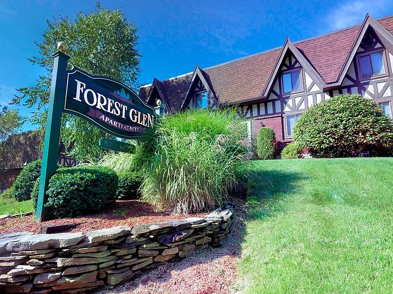 A Timeless English Tudor style apartment homes with Custom stone landscaping!