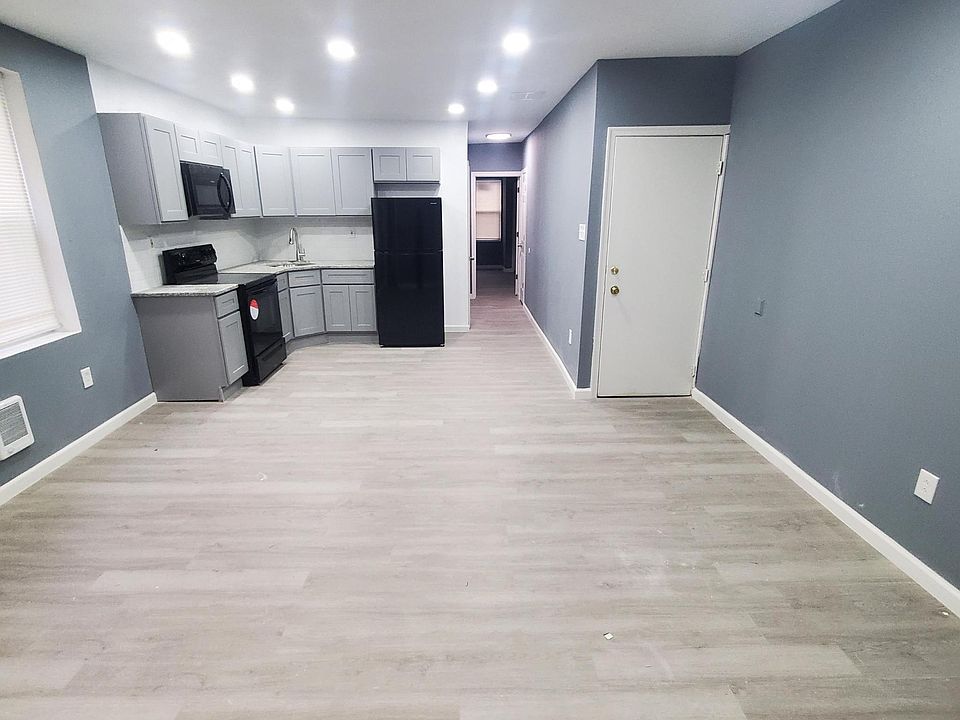 open concept apartment 792 sq feet including a living room, dining room and kitchen in this photo